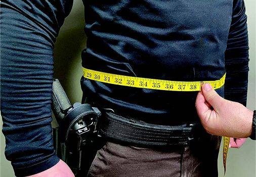 Measuring tape wrapped around mans body